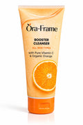 A squeeze tube of Ōra-Frame Booster Cleanser with Vitamin C and Organic Orange, featuring a bright orange and yellow gradient design with a graphic of a sliced orange on the front, set against a plain white background.